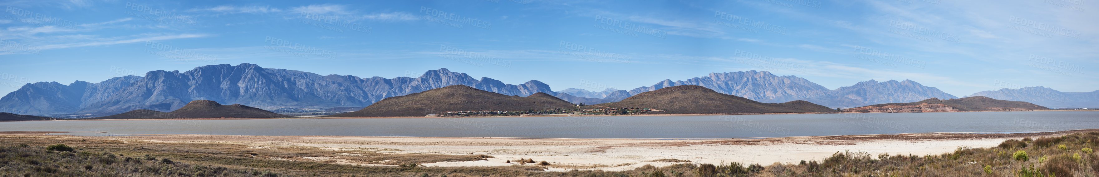 Buy stock photo Shot of a desolate landscape during the day with a small dried out dam in the middle
