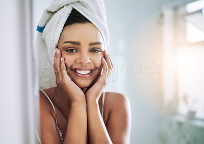 Buy stock photo Portrait of an attractive young woman looking at her face in the bathroom mirror