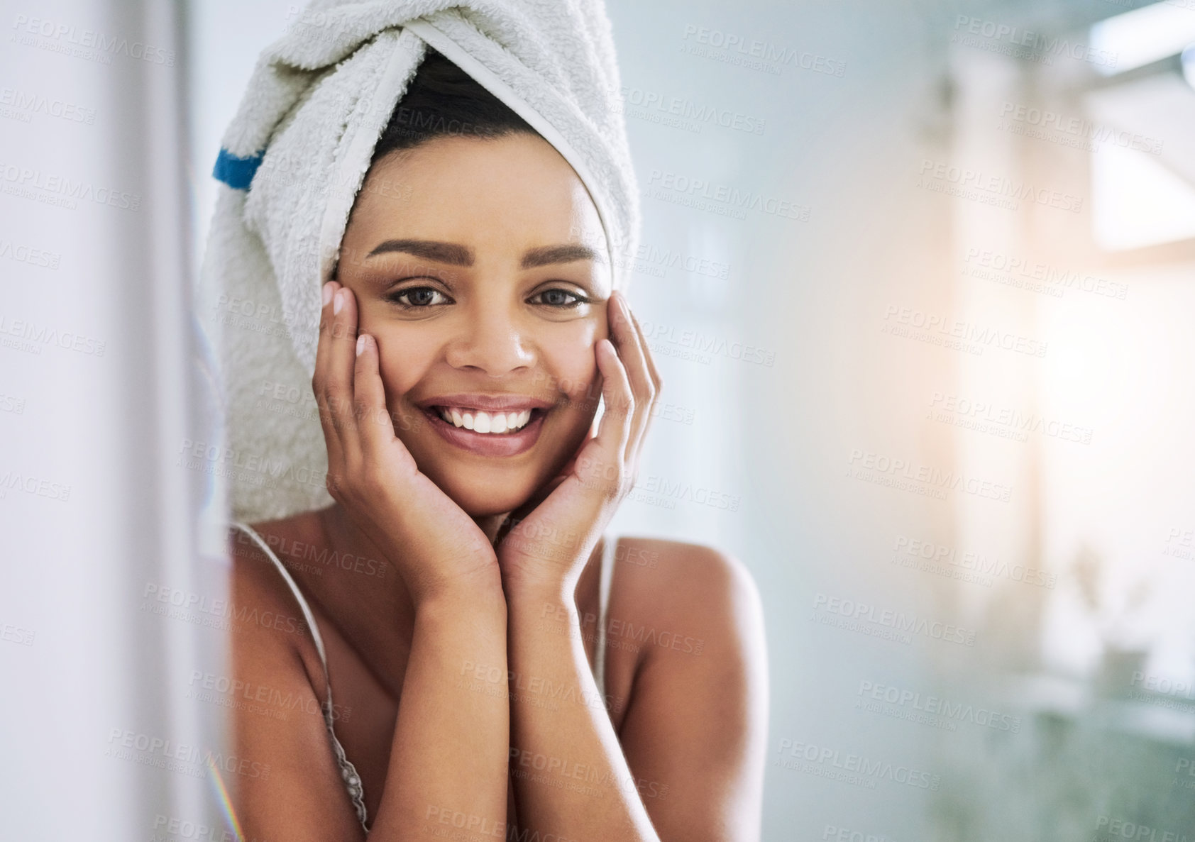 Buy stock photo Portrait of an attractive young woman looking at her face in the bathroom mirror