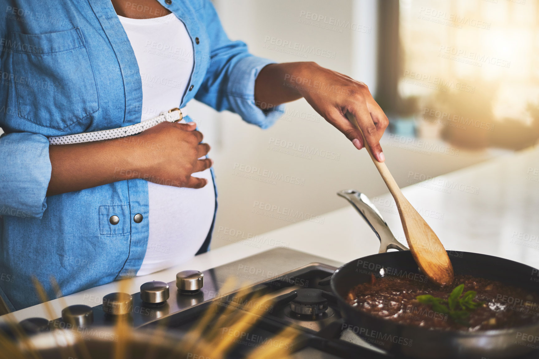 Buy stock photo Pregnant, cooking and mother in kitchen in home for healthy, wellness and diet meal with nutrition. Maternity, pasta sauce and person preparing food for dinner, supper or lunch for pregnancy benefits