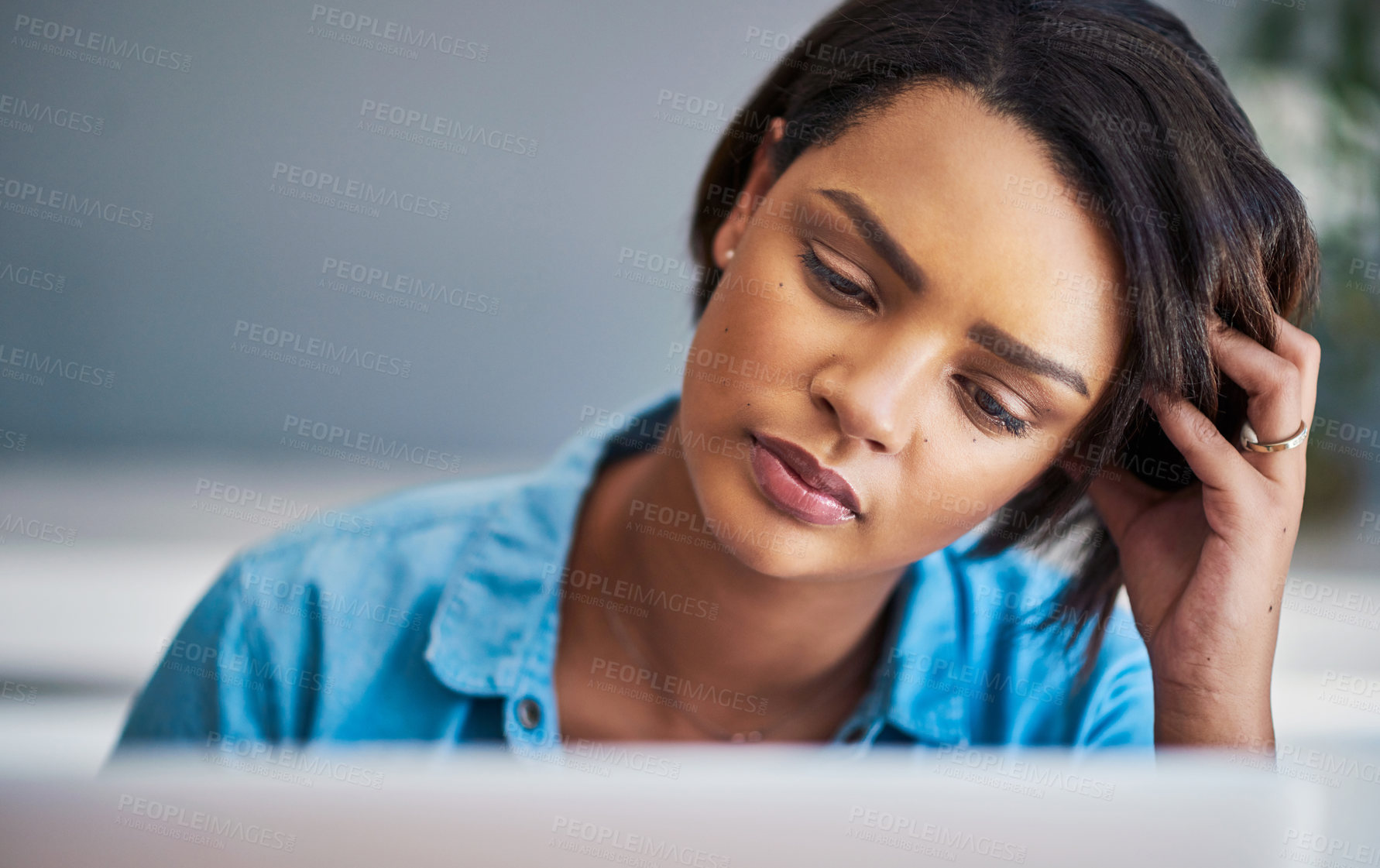 Buy stock photo Shot of an attractive young woman experiencing stress while using a laptop at home