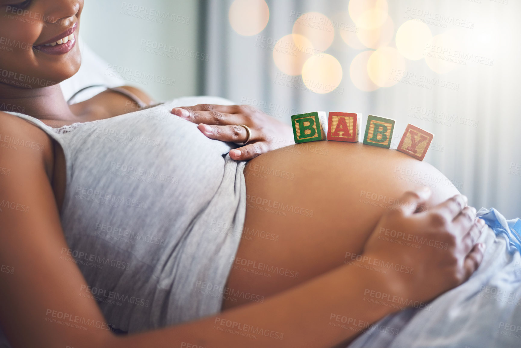 Buy stock photo Cropped shot of a pregnant woman with wooden blocks on her belly that spell the word baby