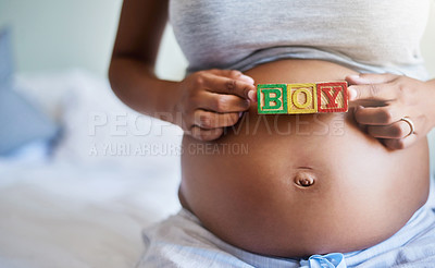 Buy stock photo Cropped shot of a pregnant woman with wooden blocks on her belly that spell the word boy