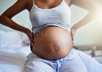 Buy stock photo Woman, pregnant and stomach bump for pregnancy, bonding and maternal health as motherhood on bed. Mother, abdomen and expecting with care for feeling movement, connection and relax in home bedroom