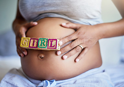 Buy stock photo Cropped shot of a pregnant woman with wooden blocks on her belly that spell the word girl