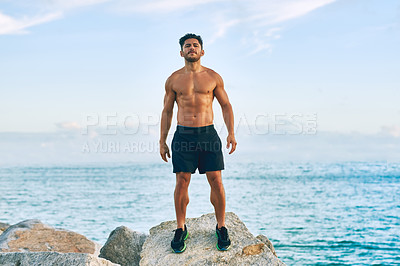 Buy stock photo Portrait of a shirtless and muscular young man standing outdoors