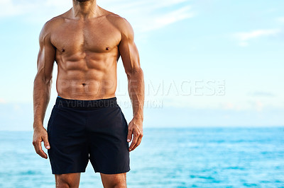 Buy stock photo Closeup shot of a shirtless and muscular young man standing outdoors