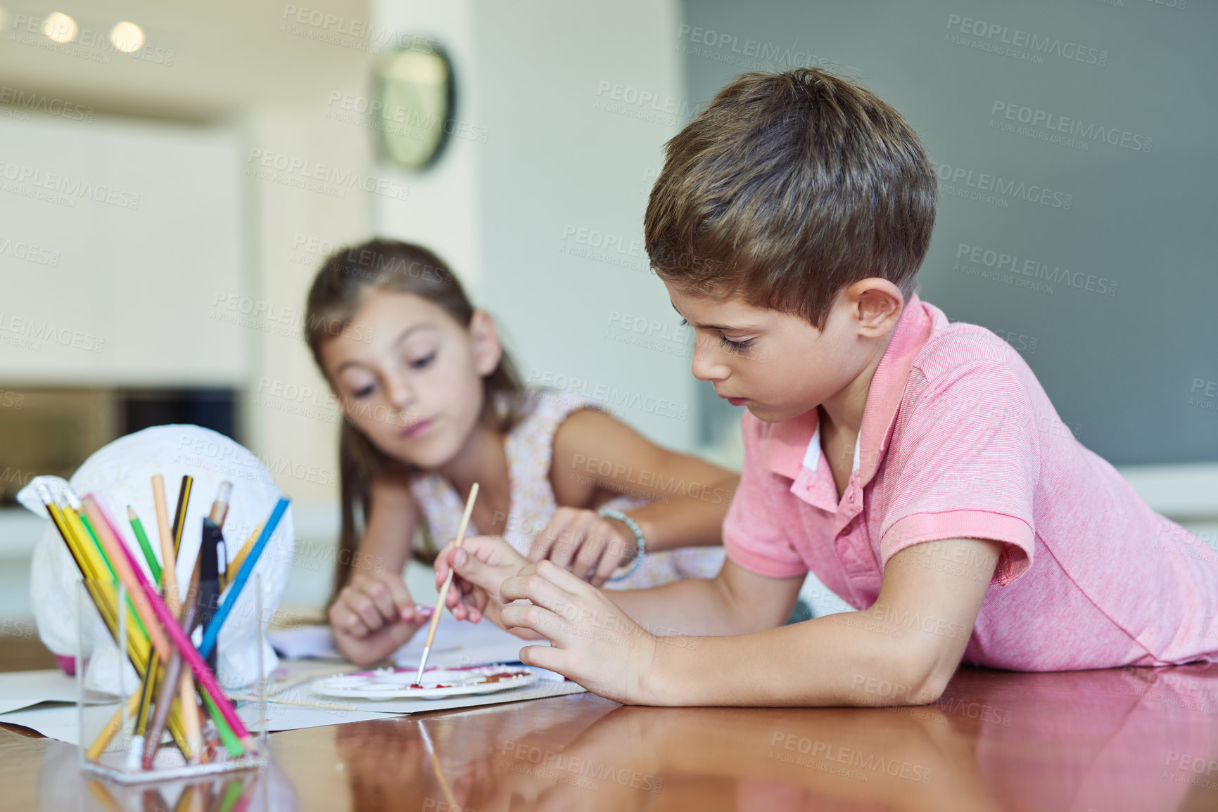 Buy stock photo Shot of two adorable little siblings painting together at home