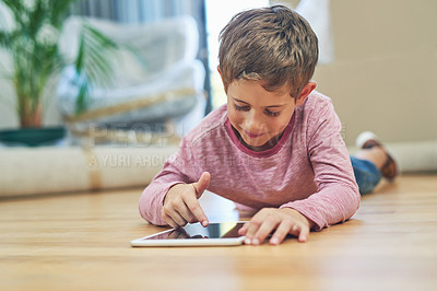 Buy stock photo Shot of an adorable little boy using a digital tablet at home on moving day