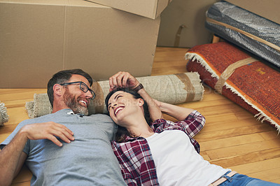 Buy stock photo Shot of a happy couple relaxing together in their home on moving day
