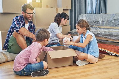 Buy stock photo Family, kids and moving with boxes for apartment as an investment for lifestyle together in a house. Children, box and parents in living room of a new home are packing for the mortgage for saving.