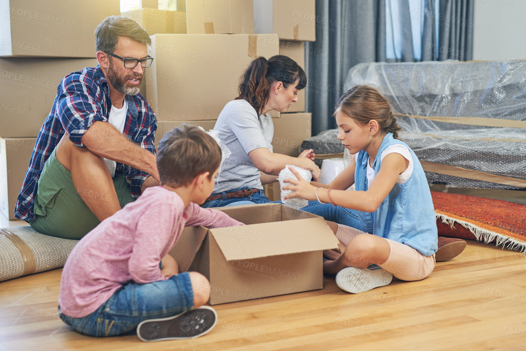 Buy stock photo Family, kids and moving with boxes for apartment as an investment for lifestyle together in a house. Children, box and parents in living room of a new home are packing for the mortgage for saving.