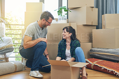 Buy stock photo Shot of a happy couple packing boxes in their home on moving day
