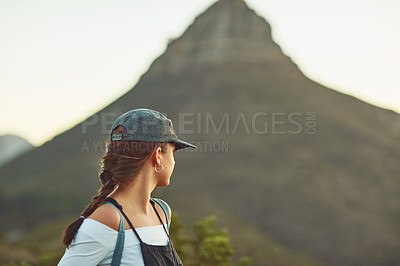 Buy stock photo Cropped shot of an unrecognizable woman looking back in nature