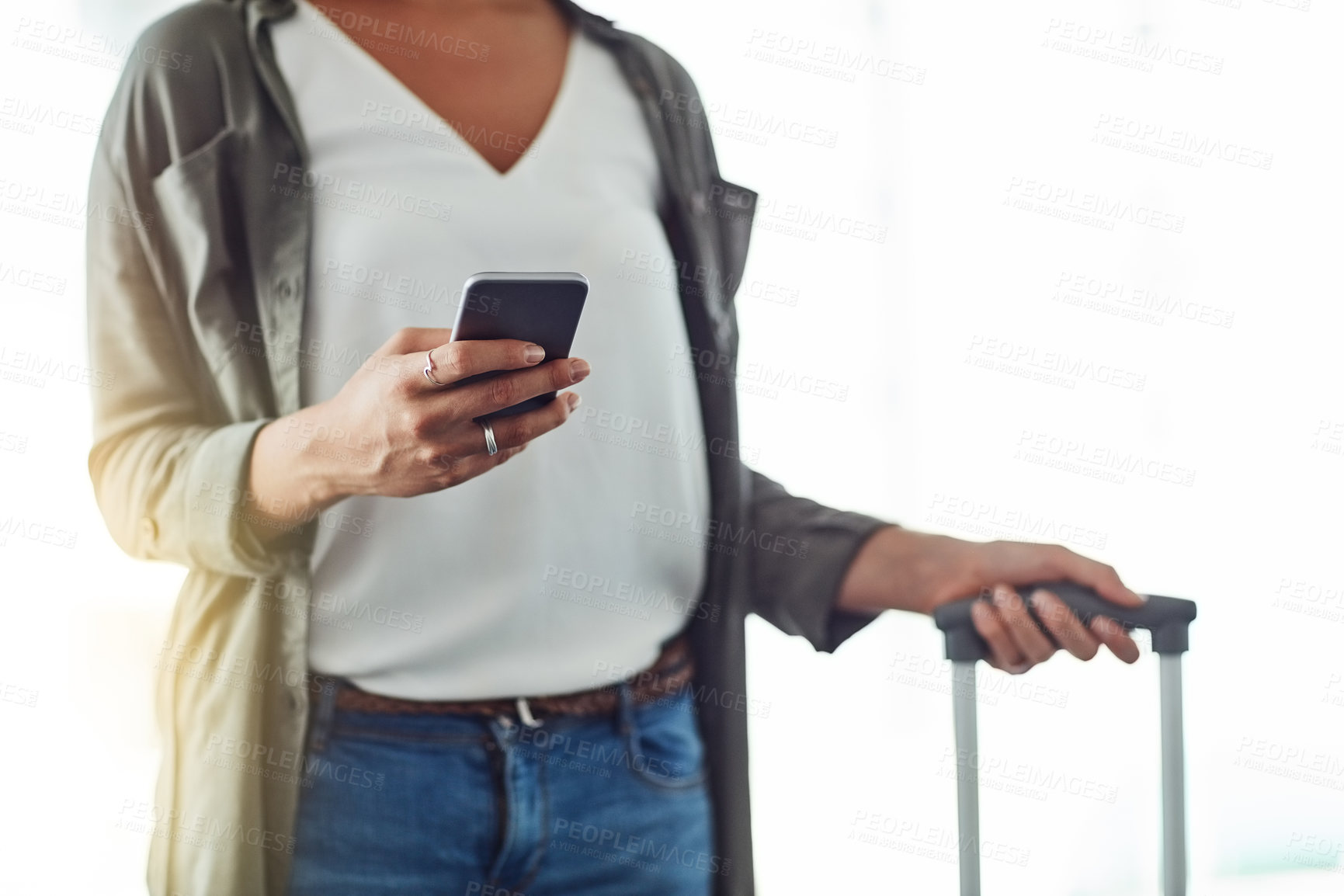 Buy stock photo Cropped shot of an unrecognizable woman using a cellphone in an airport