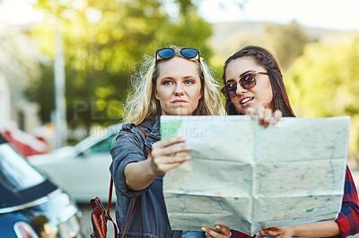 Buy stock photo Women, friends and city with map for direction, navigation or outdoor sightseeing together. Young, female people or tourists with travel guide in street or road for trip, location or destination