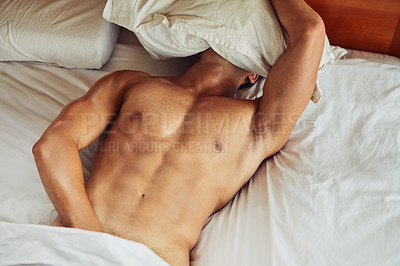 Buy stock photo Shot of an unrecognizable man lying topless on his bed while trying to sleep in the morning at home