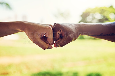 Buy stock photo Closeup shot of two unrecognizable people fist bumping outdoors