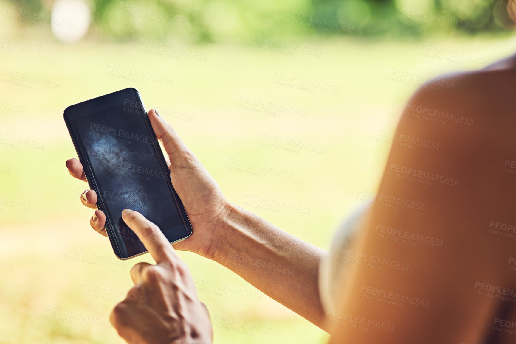 Buy stock photo Closeup shot of an unrecognizable woman using a cellphone outdoors