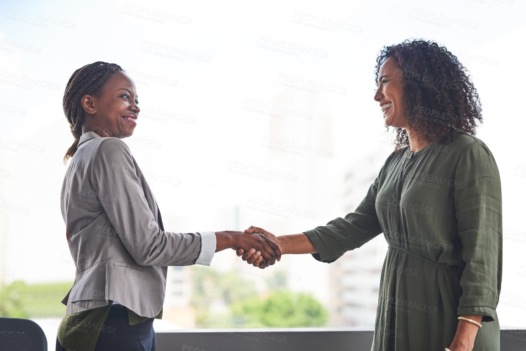 Buy stock photo Cropped shot of businesswomen shaking hands in the office