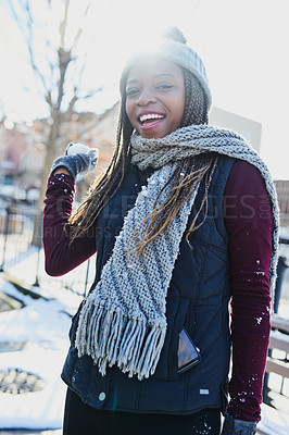 Buy stock photo Shot of a beautiful young woman throwing a snowball on a wintery day outdoors