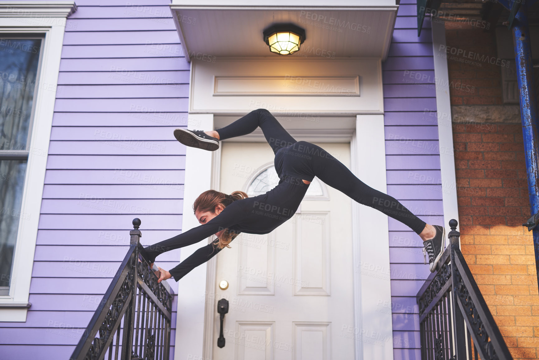 Buy stock photo Full length shot of an attractive young female athlete exercising on her front porch
