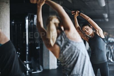 Buy stock photo Rearview shot of women working out in the gym