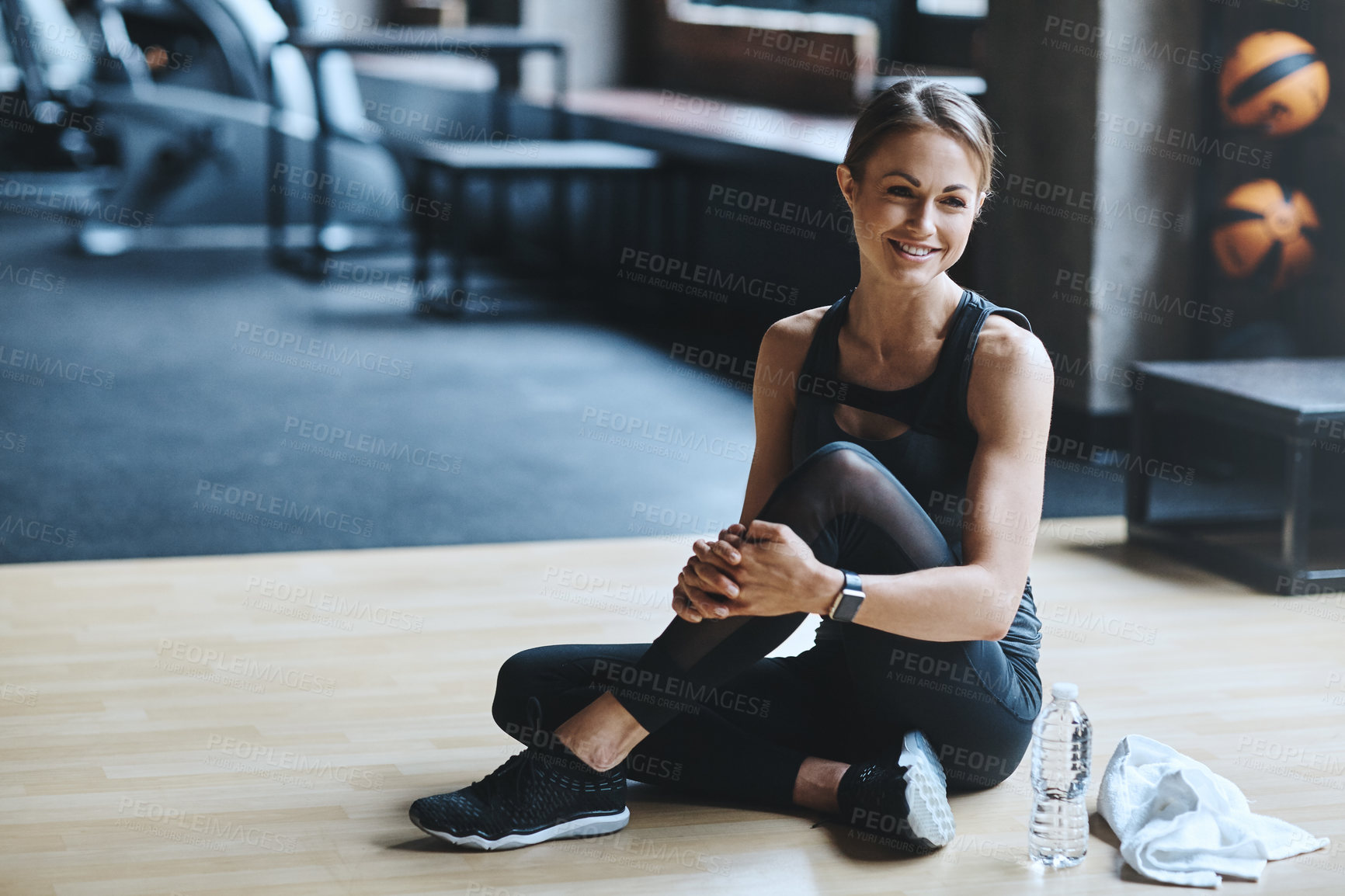 Buy stock photo Shot of an attractive young woman working out in the gym