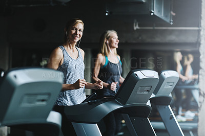 Buy stock photo Shot of mature women working out in the gym