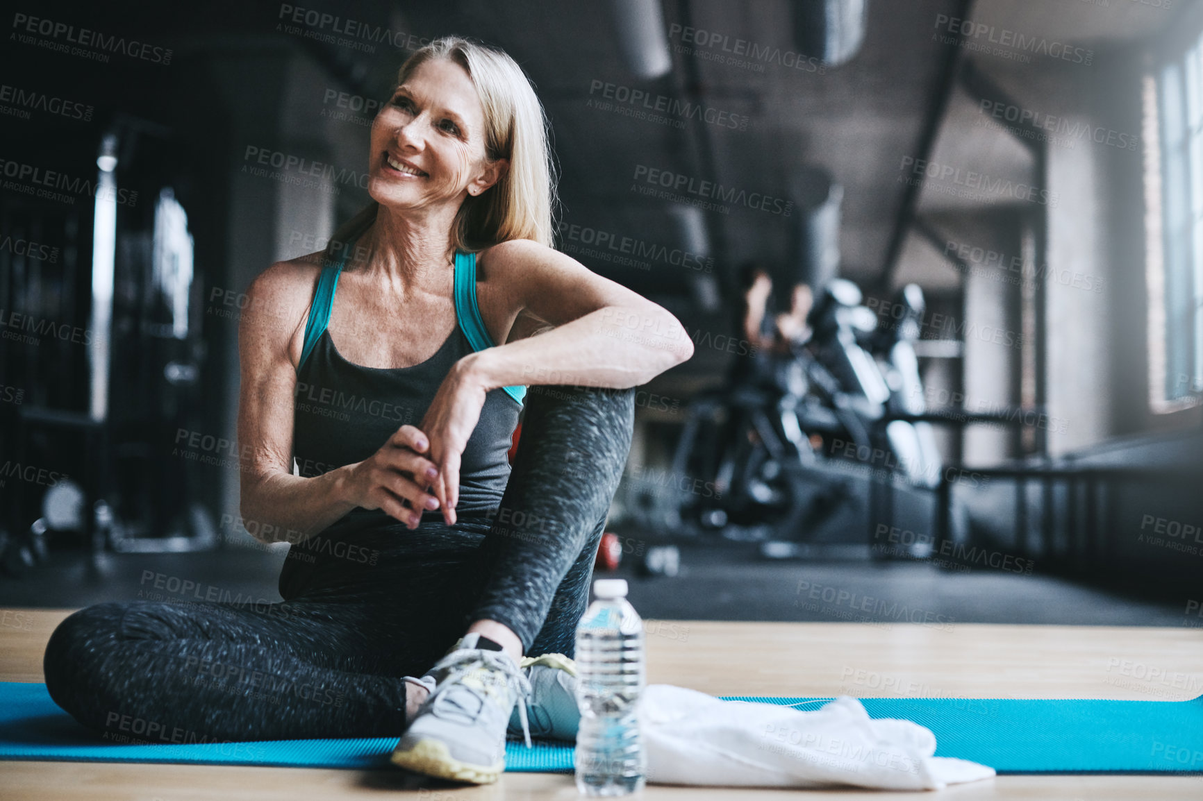 Buy stock photo Full length shot of an attractive mature woman working out in the gym