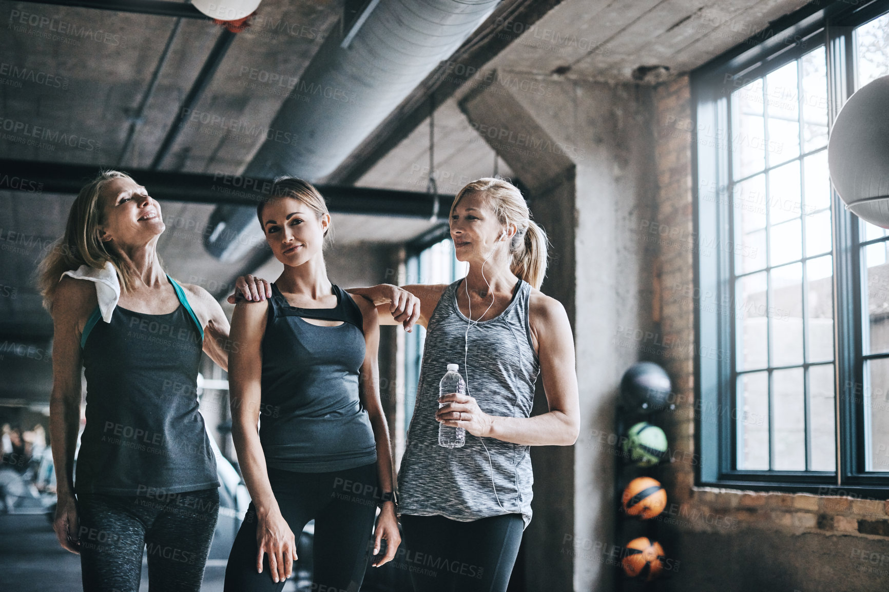 Buy stock photo Cropped portrait of three attractive and athletic women working out in the gym