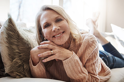 Buy stock photo Shot of an attractive mature woman relaxing on the sofa at home