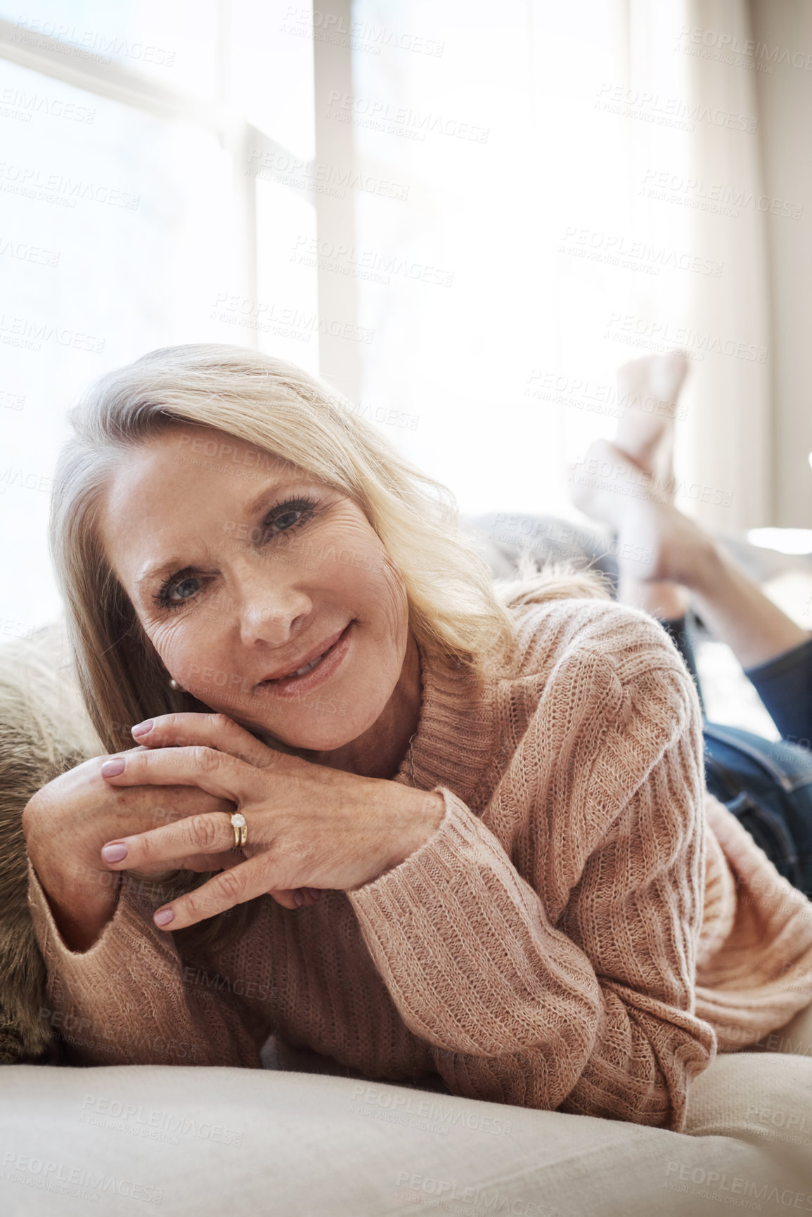 Buy stock photo Shot of an attractive mature woman relaxing on the sofa at home