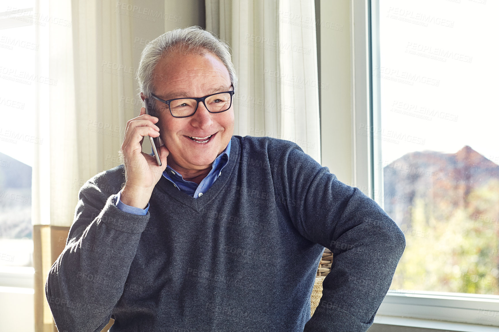 Buy stock photo Cropped shot of a senior man on a call at home
