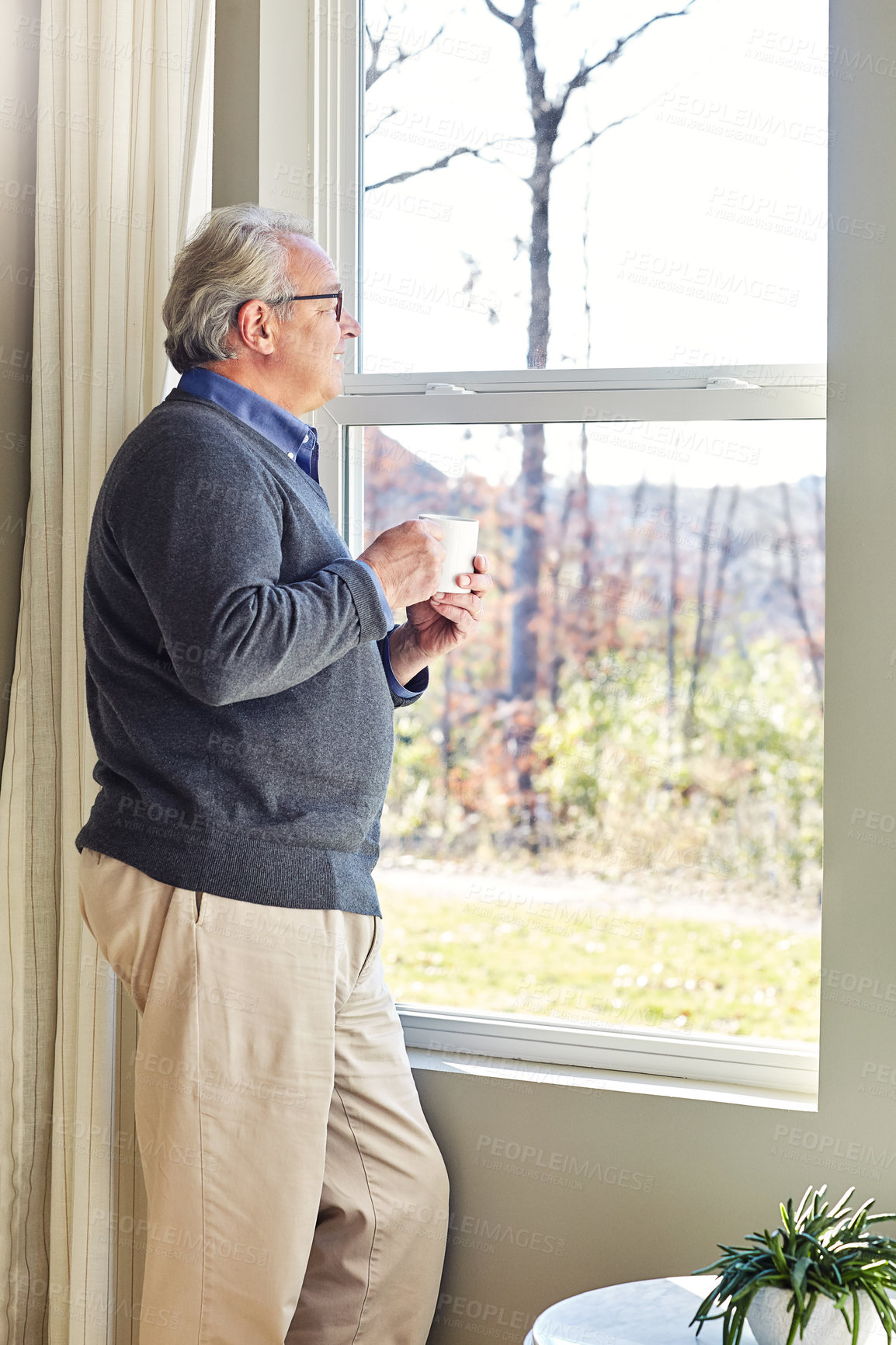 Buy stock photo Cropped shot of a senior man relaxing at home