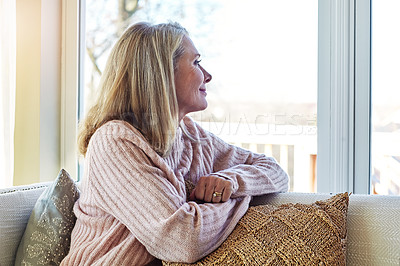 Buy stock photo Cropped shot of an attractive mature woman relaxing at home