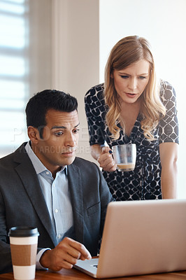 Buy stock photo Cropped shot of two young businesspeople working together in a modern office