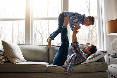 Buy stock photo Shot of a father and his little son having fun at home