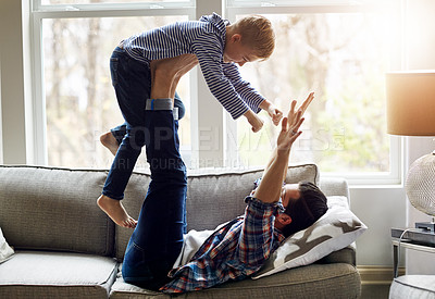 Buy stock photo Shot of a father and his little son having fun at home