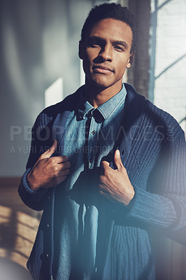 Buy stock photo Shot of a handsome young businessman standing in a modern office