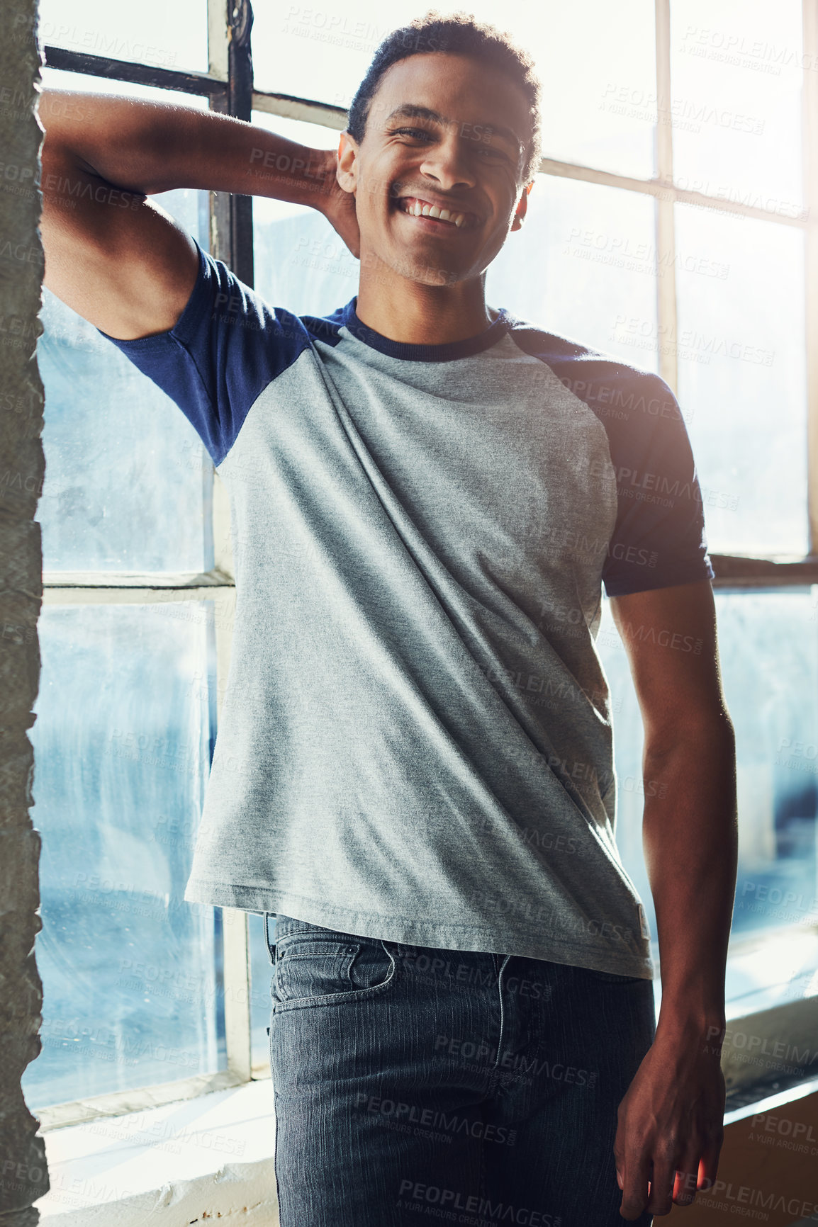 Buy stock photo Cropped portrait of a handsome young sportsman standing with his hand behind his head