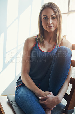 Buy stock photo Cropped portrait of an attractive young sportswoman sitting on a wooden chair