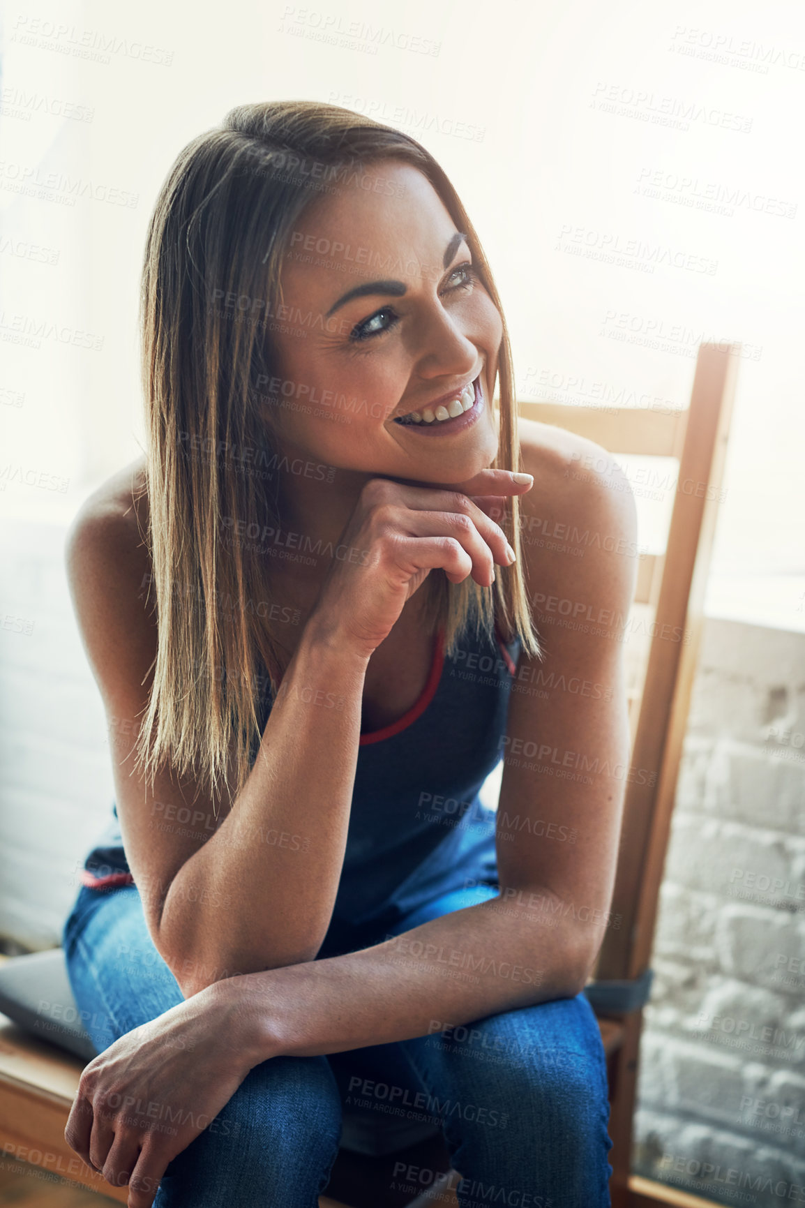 Buy stock photo Cropped shot of an attractive young sportswoman looking thoughtful while sitting on a wooden chair