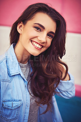 Buy stock photo Portrait of a beautiful young woman posing against a wall outside