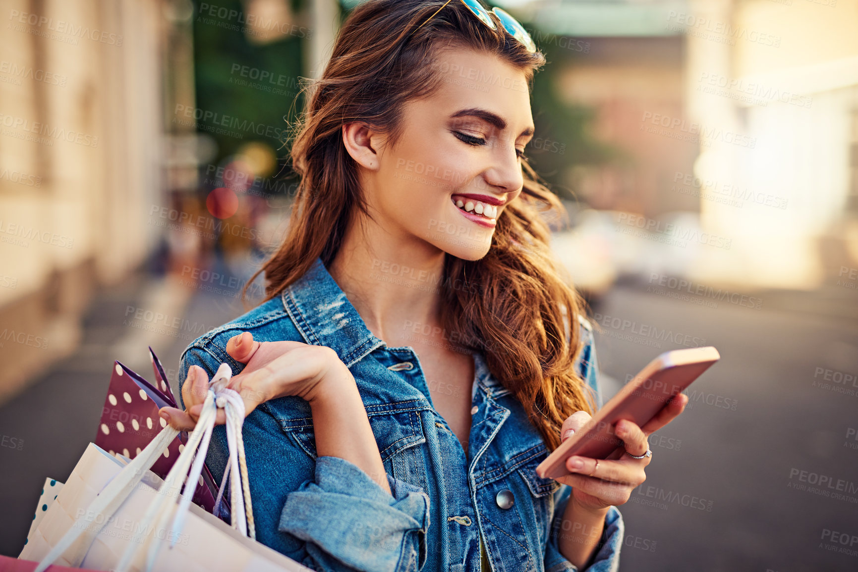 Buy stock photo Cropped shot of a beautiful young woman on a shopping spree in the city