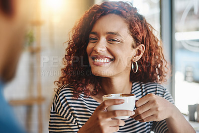 Buy stock photo Shot of a young woman having coffee with her boyfriend in a cafe