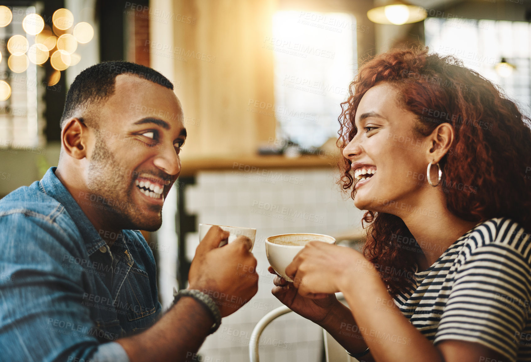Buy stock photo Cropped shot of an affectionate young couple enjoying their date in the coffee shop