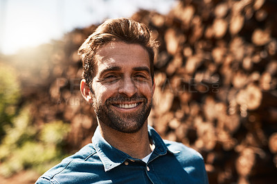 Buy stock photo Cropped portrait of a lumberjack standing in front of a pile of wood