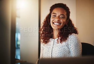 Buy stock photo Portrait of a young businesswoman using a computer during a late night at work in a modern office