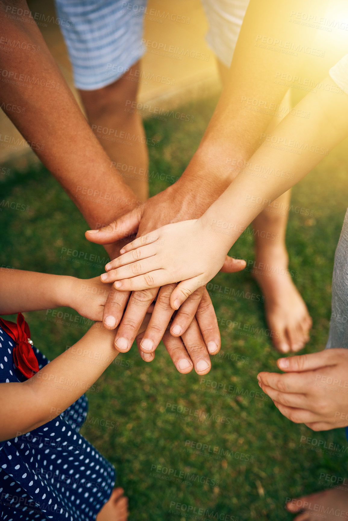 Buy stock photo Cropped shot of an unrecognizable father and his children joining hands in unity outside